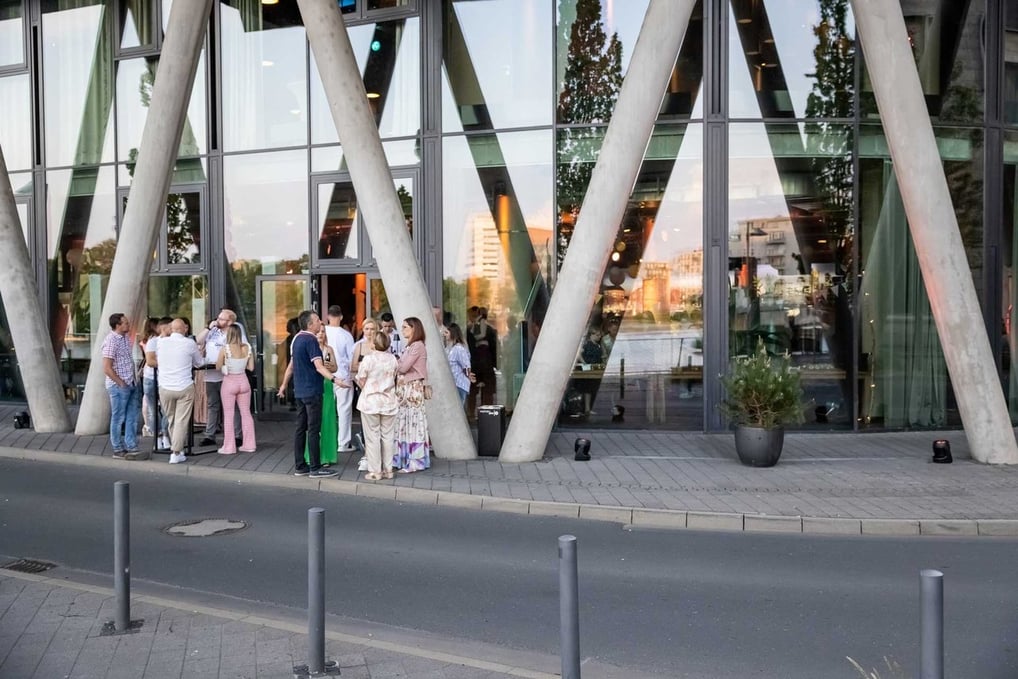 Gäste treffen sich vor der Eventlocation Westhafen Pier 1 in Frankfurt am Main